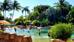 People swimming in tropical resort lagoon